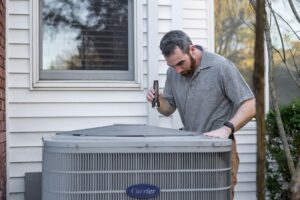 professional servicing home air conditioning system