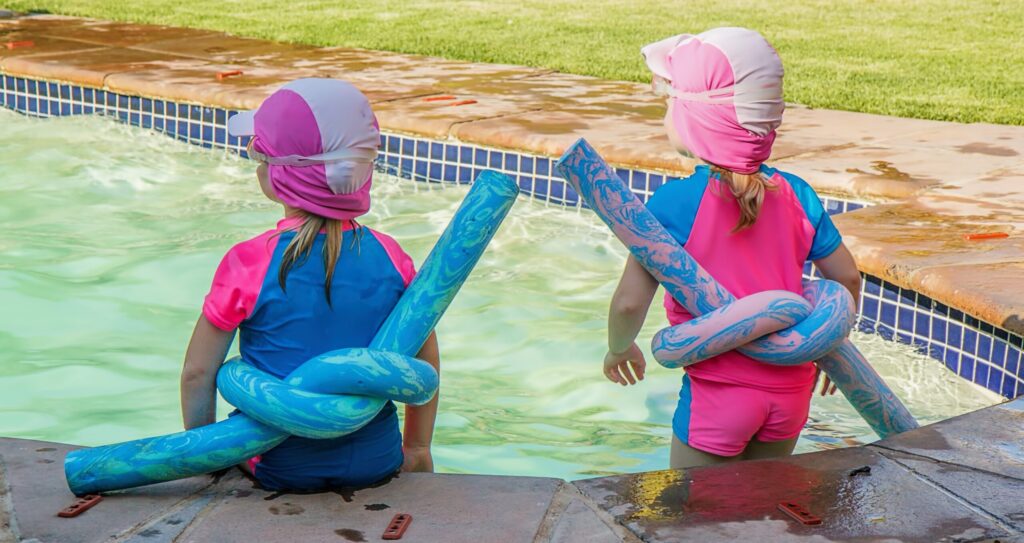two little girls with floatation devices on