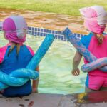 two little girls with floatation devices on