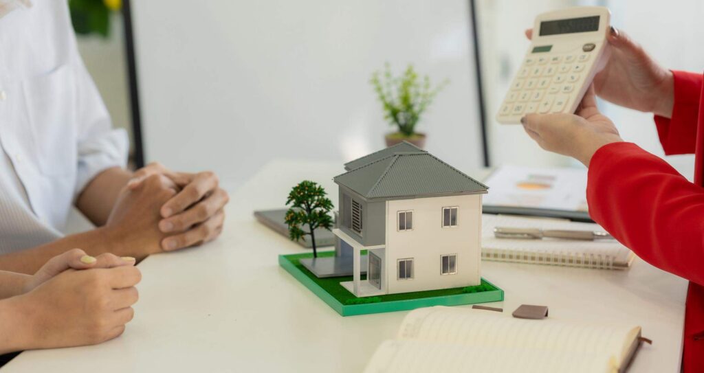 Insurance adjuster showing homeowners calculation of how much it will cost to replace their damaged property