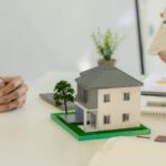Insurance adjuster showing homeowners calculation of how much it will cost to replace their damaged property